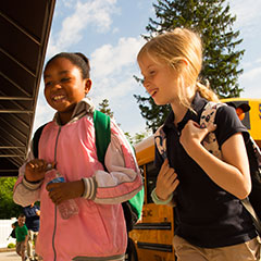 Two students smiling, entering the school. Links to Beneficiary Designations Two students smiling, entering the school. Links to Beneficiary Designations